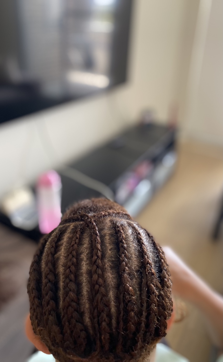 A clean stitch cornrow base, photographed top-down.